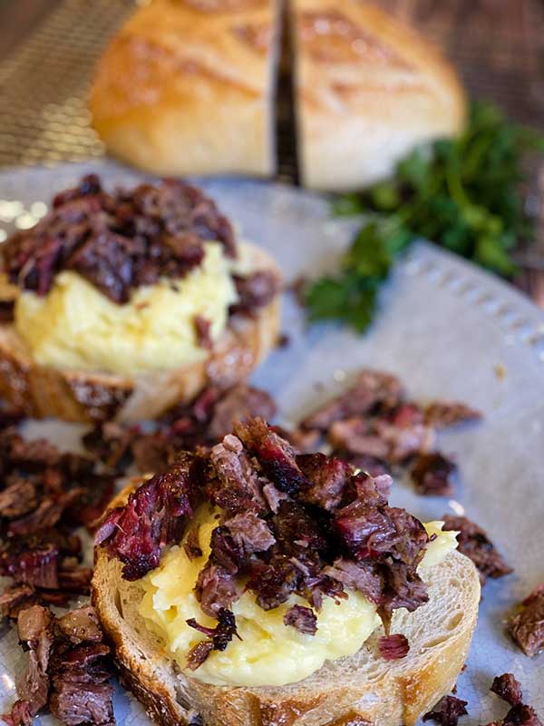 Layers of chuck roast on open-faced hot beef sandwich