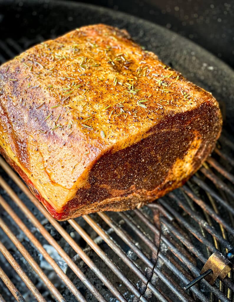 prime rib on a grill sitting over indirect heat.