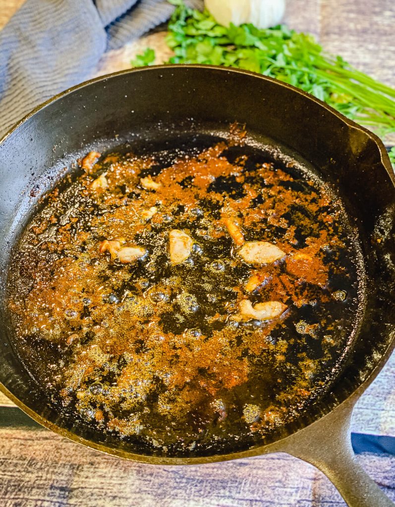 garlic cooking in cast iron pan