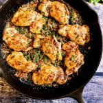 garlic parmesan chicken thighs finished in cast iron pan