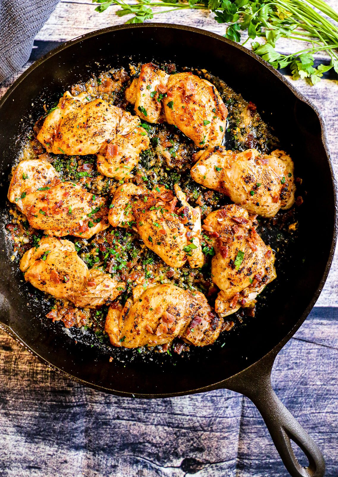 garlic parmesan chicken thighs finished in cast iron pan