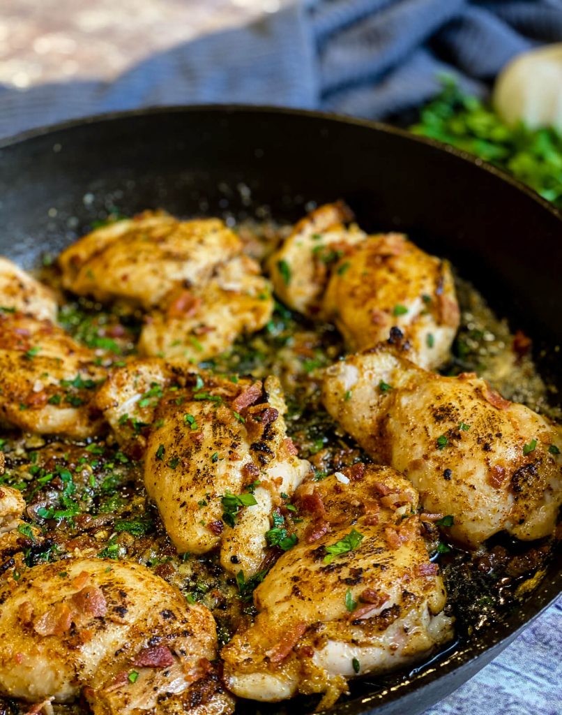 garlic parmesan chicken thighs with bacon in cast iron pan