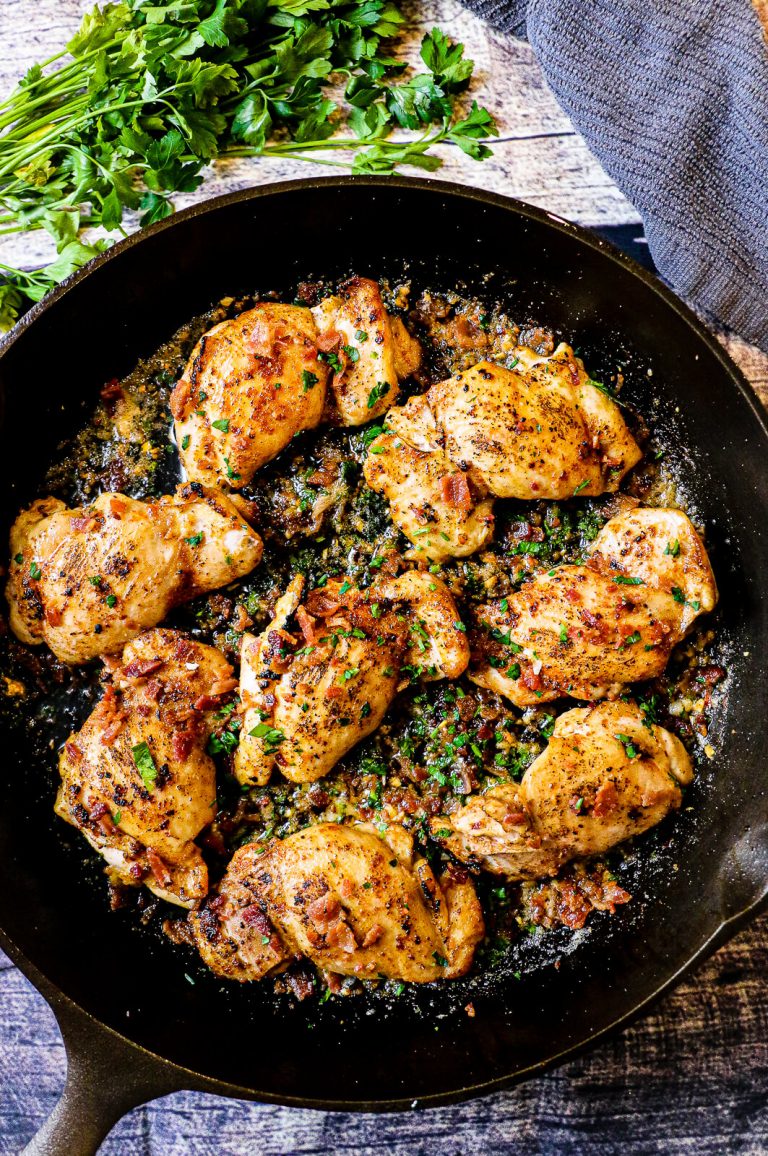 garlic parmesan chicken thighs with bacon in a cast iron pan