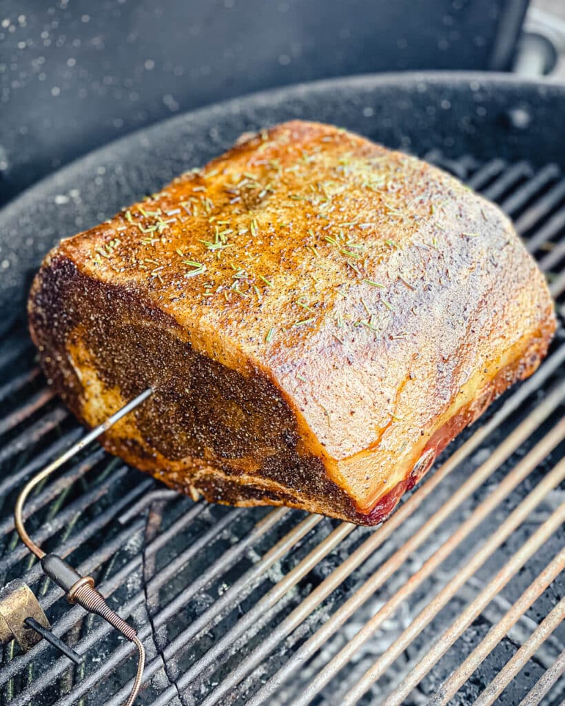 prime rib on a grill over indirect heat