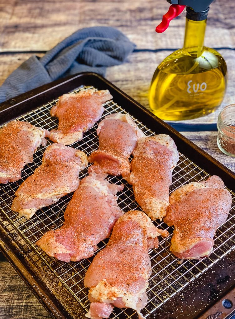 uncooked chicken thighs on wire rack