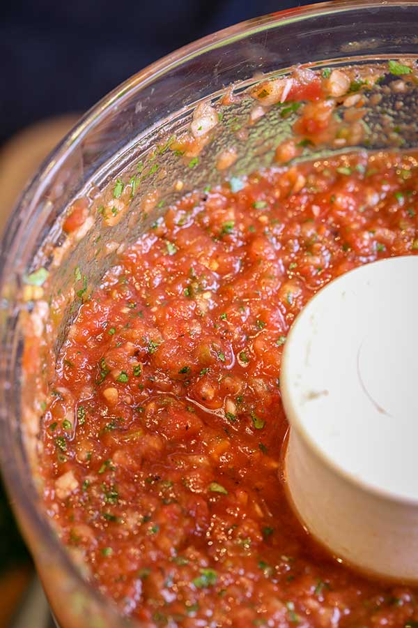 Food processor with restaurant style salsa processed and ready to serve.