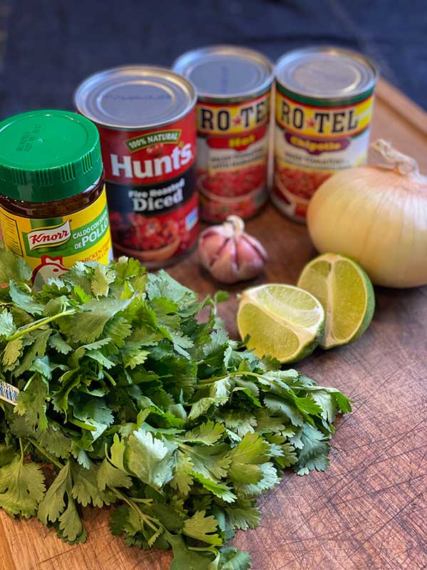 Ingredients for the restaurant style salsa: chicken bouillon, cilantro, garlic, onion, lime, and canned tomatoes.