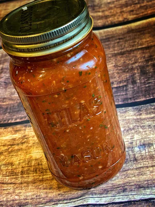 Restaurant style salsa stored in a glass jar.