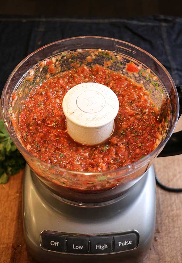 Food processor with restaurant style salsa processed and ready to serve.