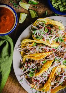 mexican street tacos with limes and salsa