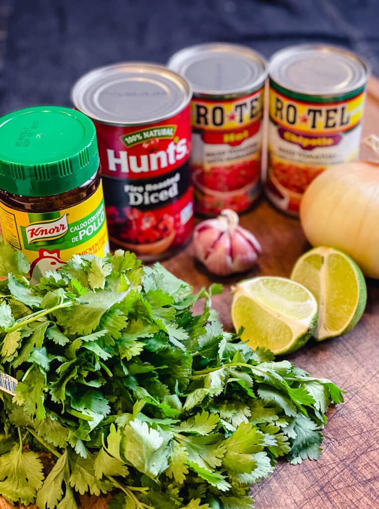 raw ingredients for restaurant style salsa on a cutting board