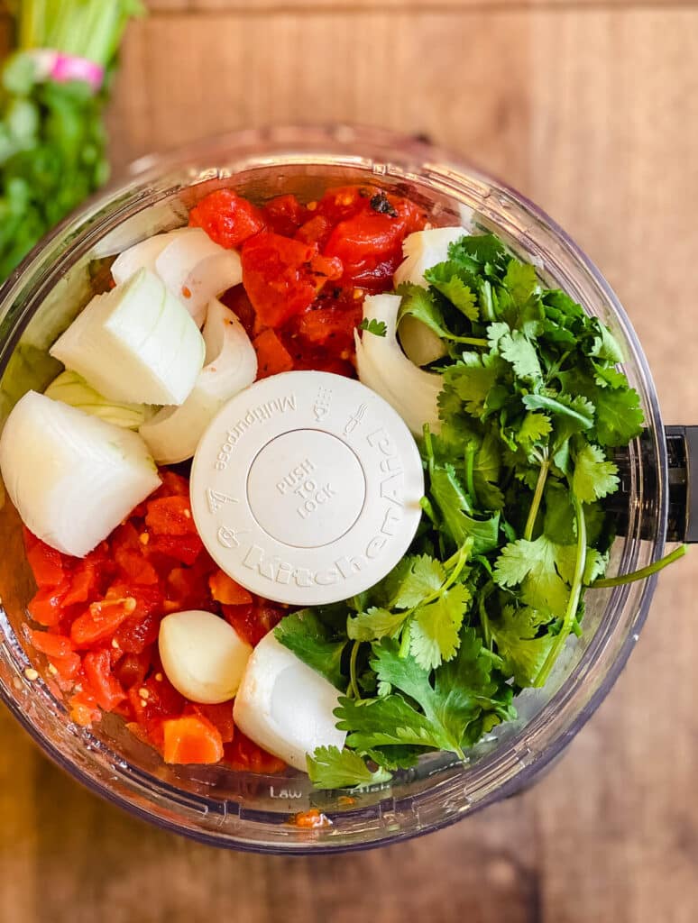 ingredients for restaurant style salsa in a food processor