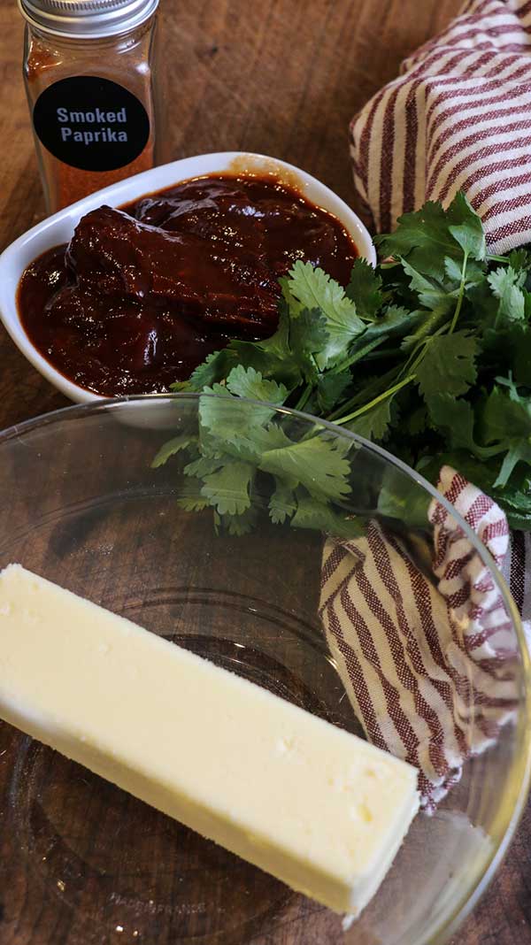 Step one for making smoky chipotle butter is to add room temperature butter into a bowl