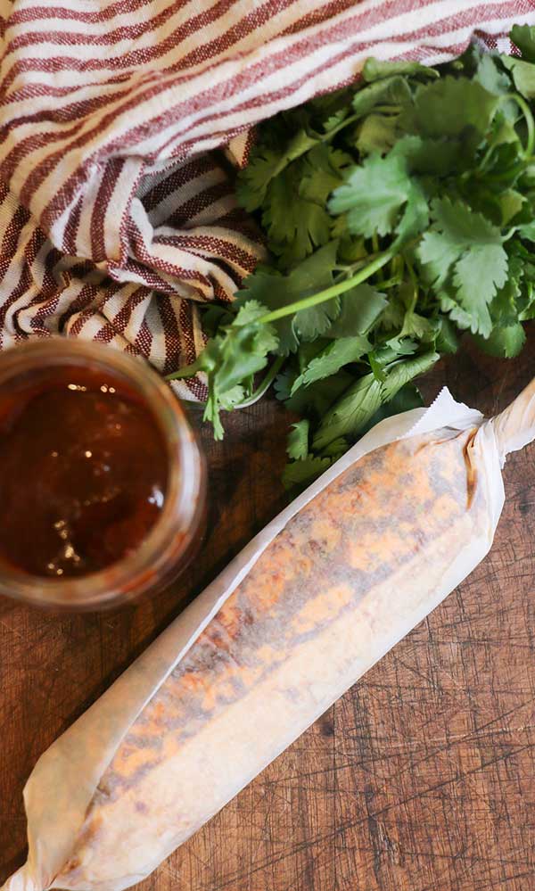 chipotle butter rolled into a log in parchment paper with paper twisted at the ends to seal it