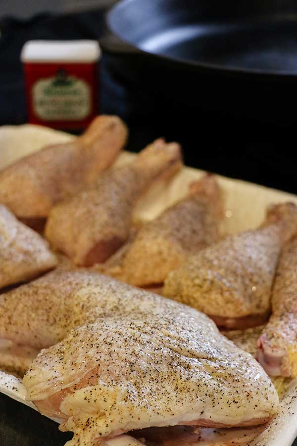 Chicken seasoned with salt and pepper prepared for Pan-fried Smoked Chicken Paprikash