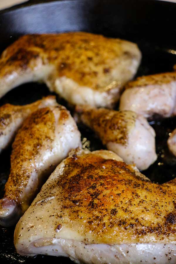 Seared chicken in cast-iron skillet for Pan-fried Smoked Chicken Paprikash