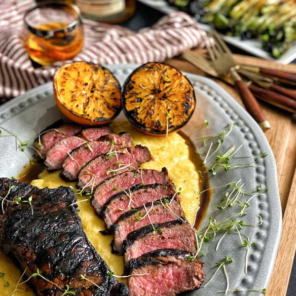Bourbon marinated strip steak, grilled and served on a bed of polenta