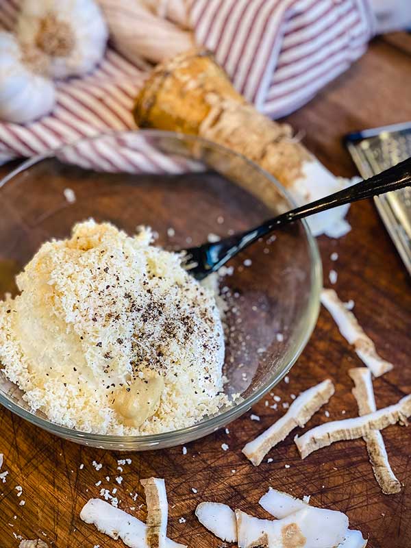 grated horseradish, pepper, onion, garlic and dijon mustard over sour cream in a bowl