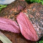 Smoked eye of round roast beef on a cutting board
