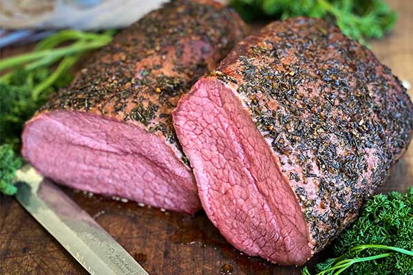 Smoked eye of round roast beef on a cutting board