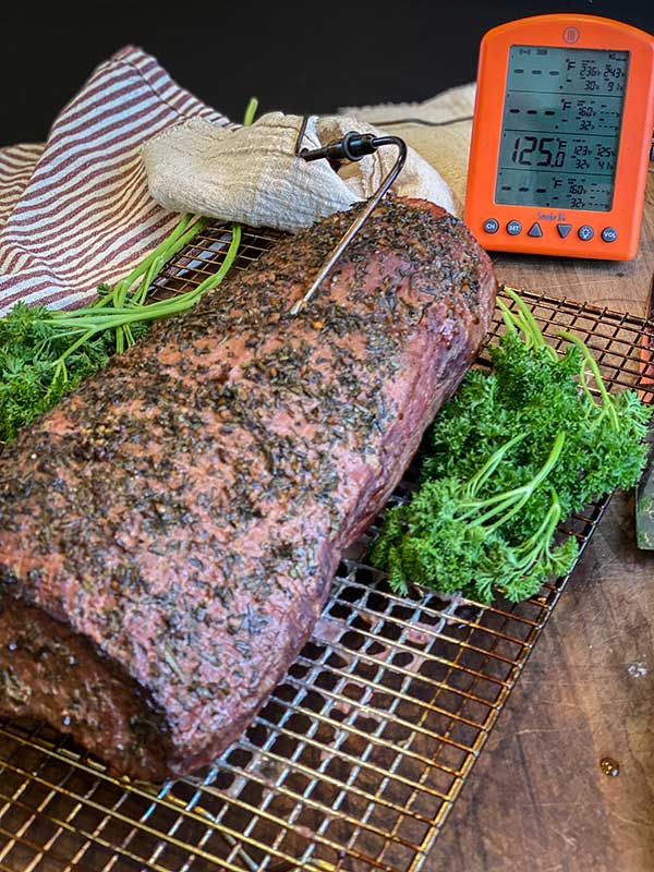 smoked eye of roast beef cooling on a rack