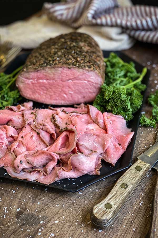 Smoked eye of round roast beef on a platter