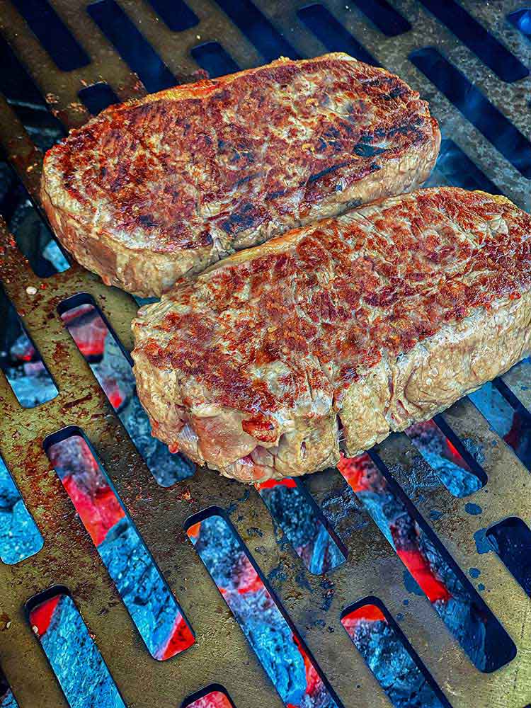 crust forming on New York strip steak as it grills
