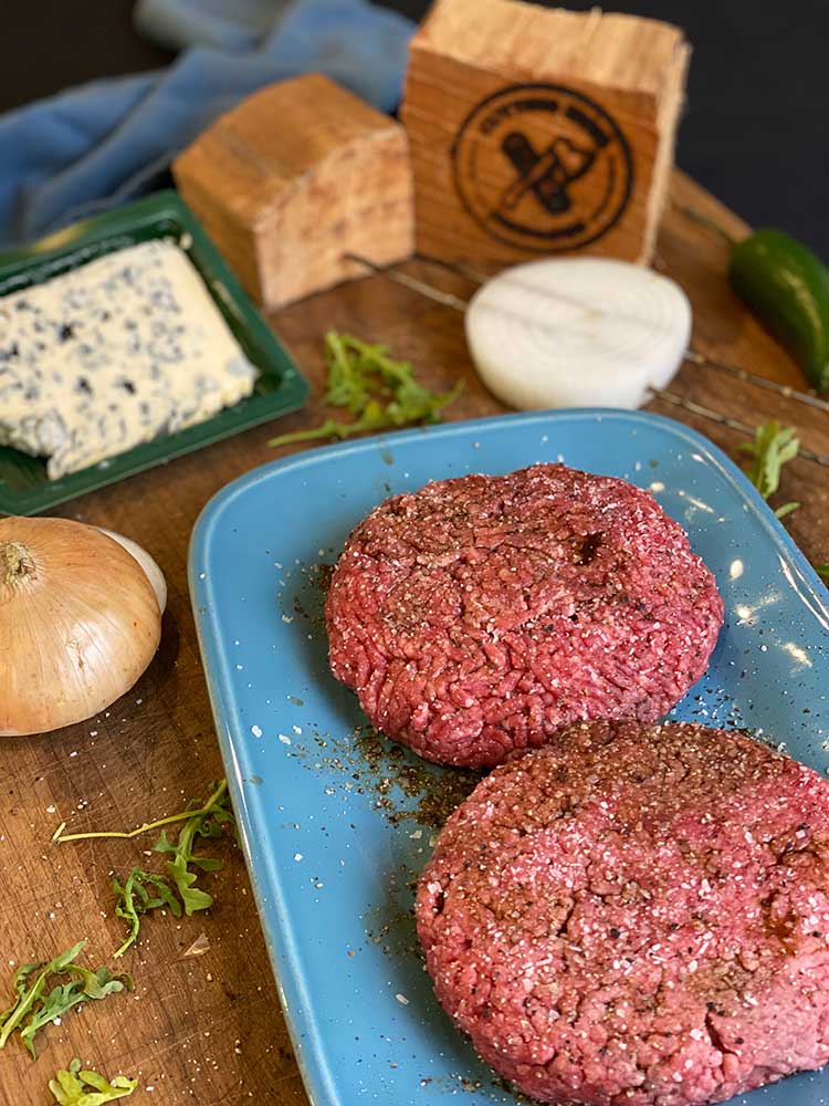 Seasoned hamburger patties ready for the grill