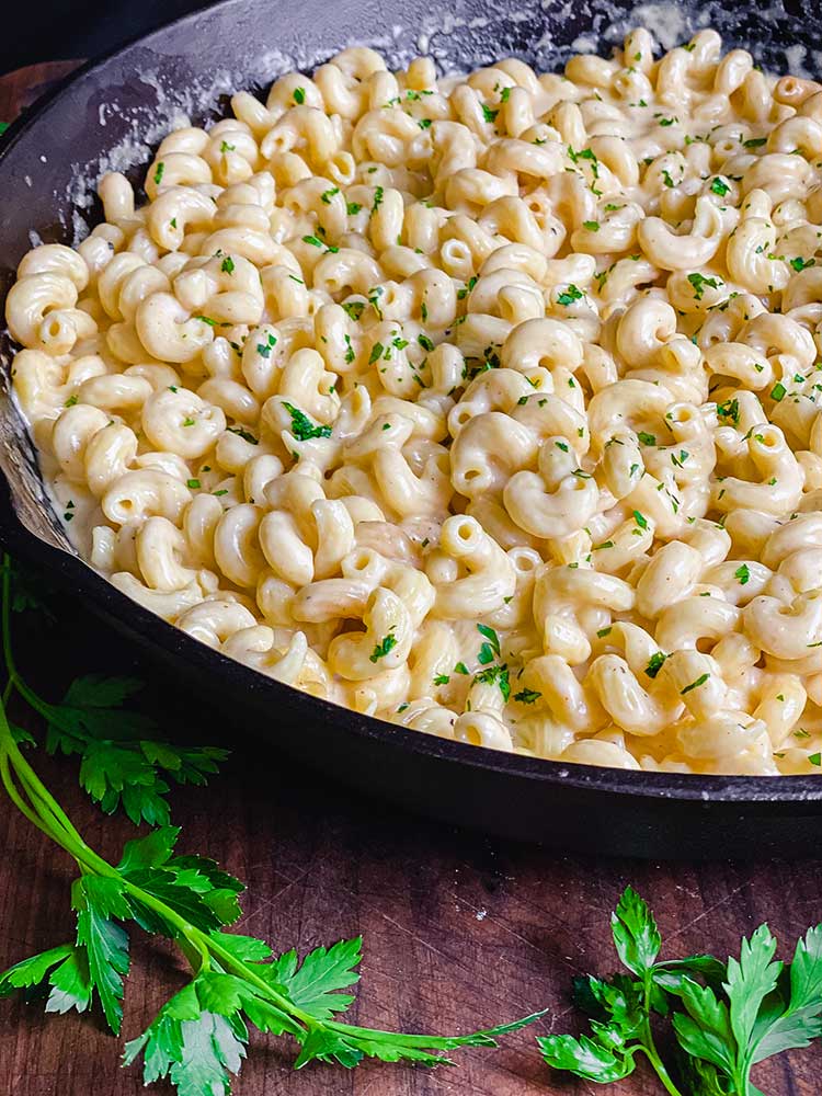 cavatappi pasta with melted cheese in cast iron skillet