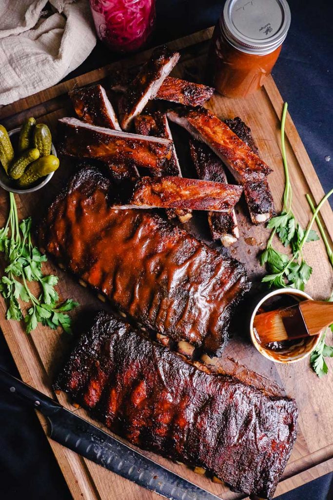 Overhead shot of barbecue ribs sliced with sauces