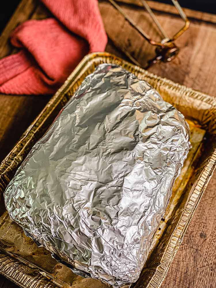 Place foil wrapped pork shoulder in drip pan