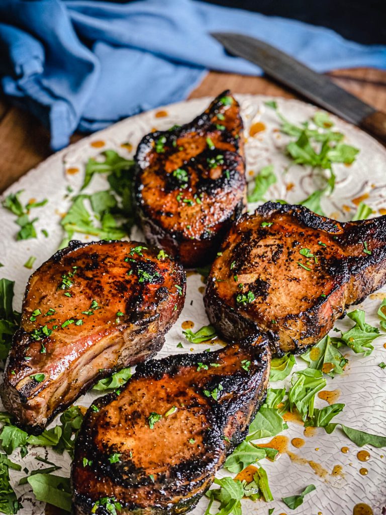 grilled maple glazed pork chops on a platter
