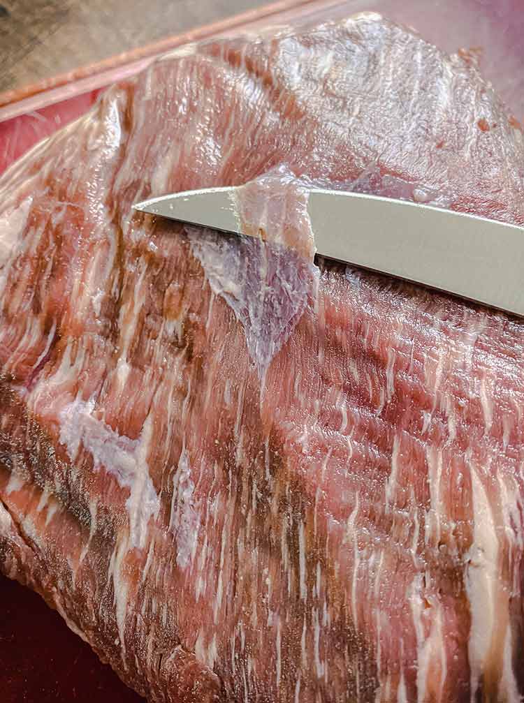 slicing off the silver skin of a tri-tip is easy with a sharp boning knife