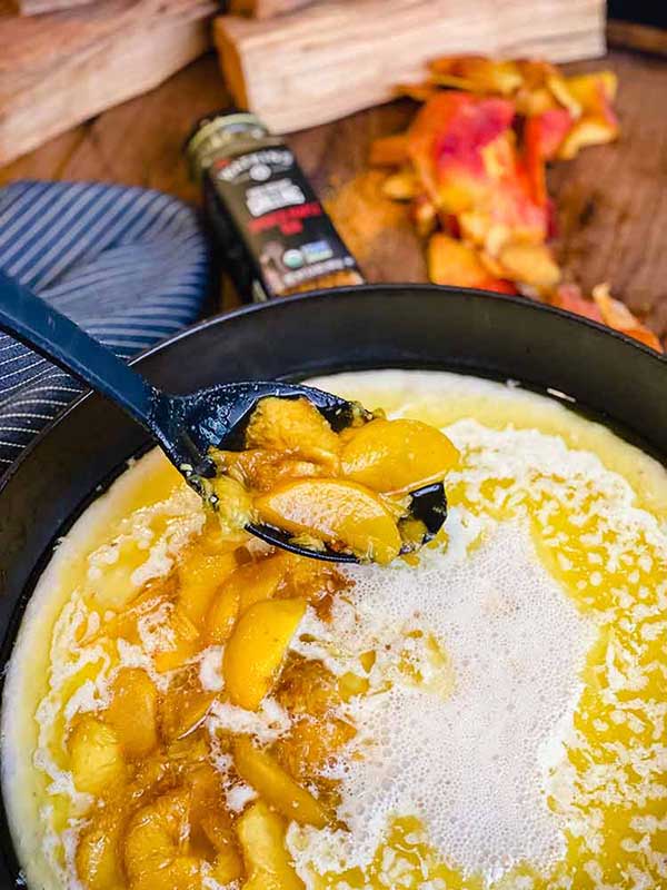 Adding peaches to the cobbler batter