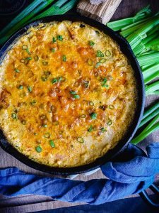 smoked chicken buffalo dip sprinkled with green onions and ready to eat