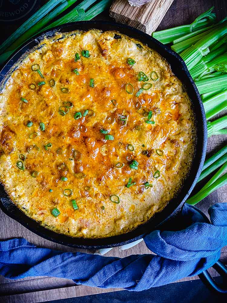 smoked chicken buffalo dip sprinkled with green onions and ready to eat