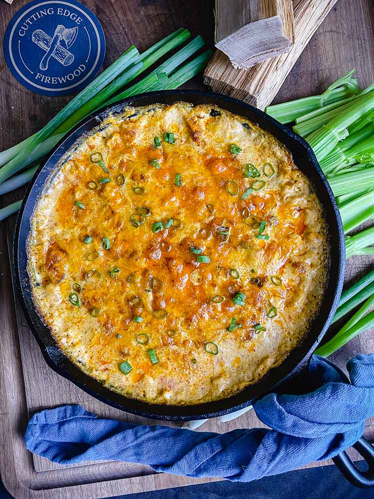 Smoked Buffalo chicken dip garnished with green onions