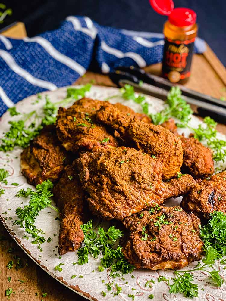 platter of smoke fried chicken sprinkled with parsley