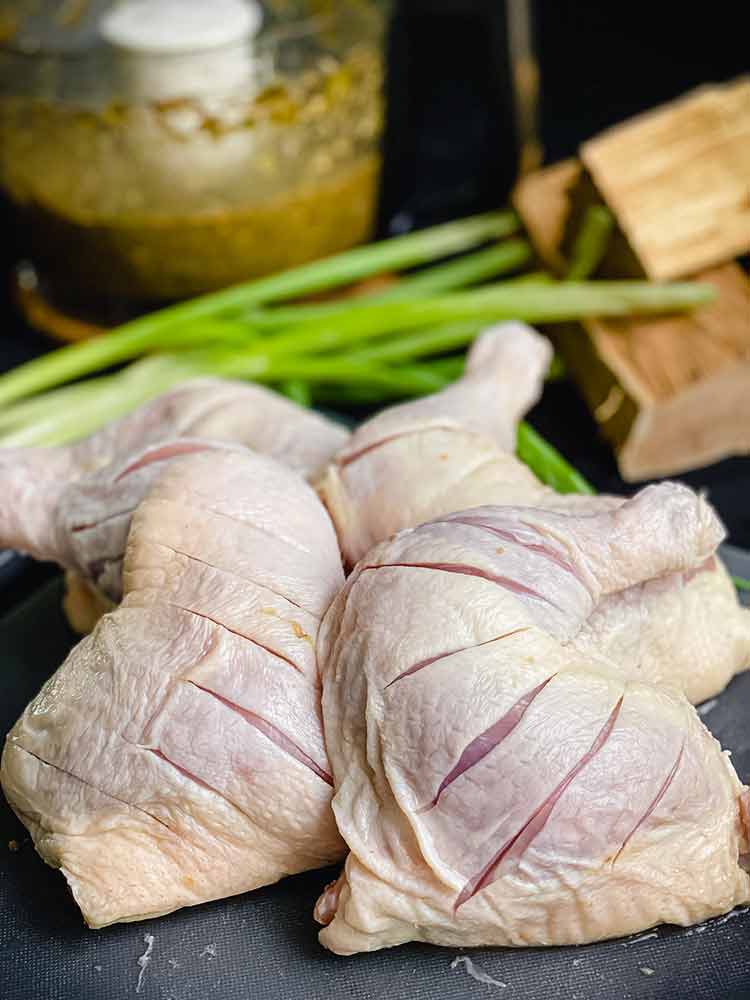 chicken quarters with quarter inch slices to allow for the marinade to penetrate the meat