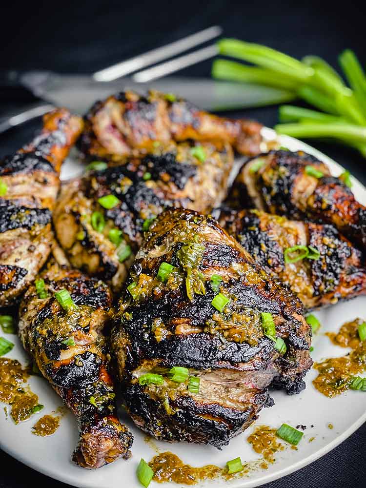 platter of chicken garnished with chopped green onions.