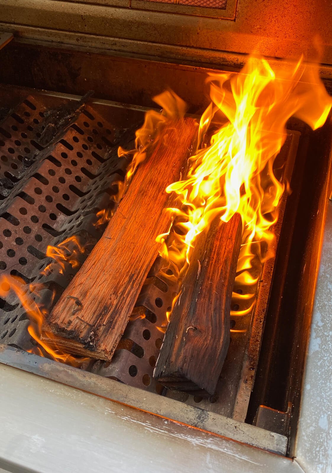 wood burning on a grill for authentic Caribbean jerk chicken