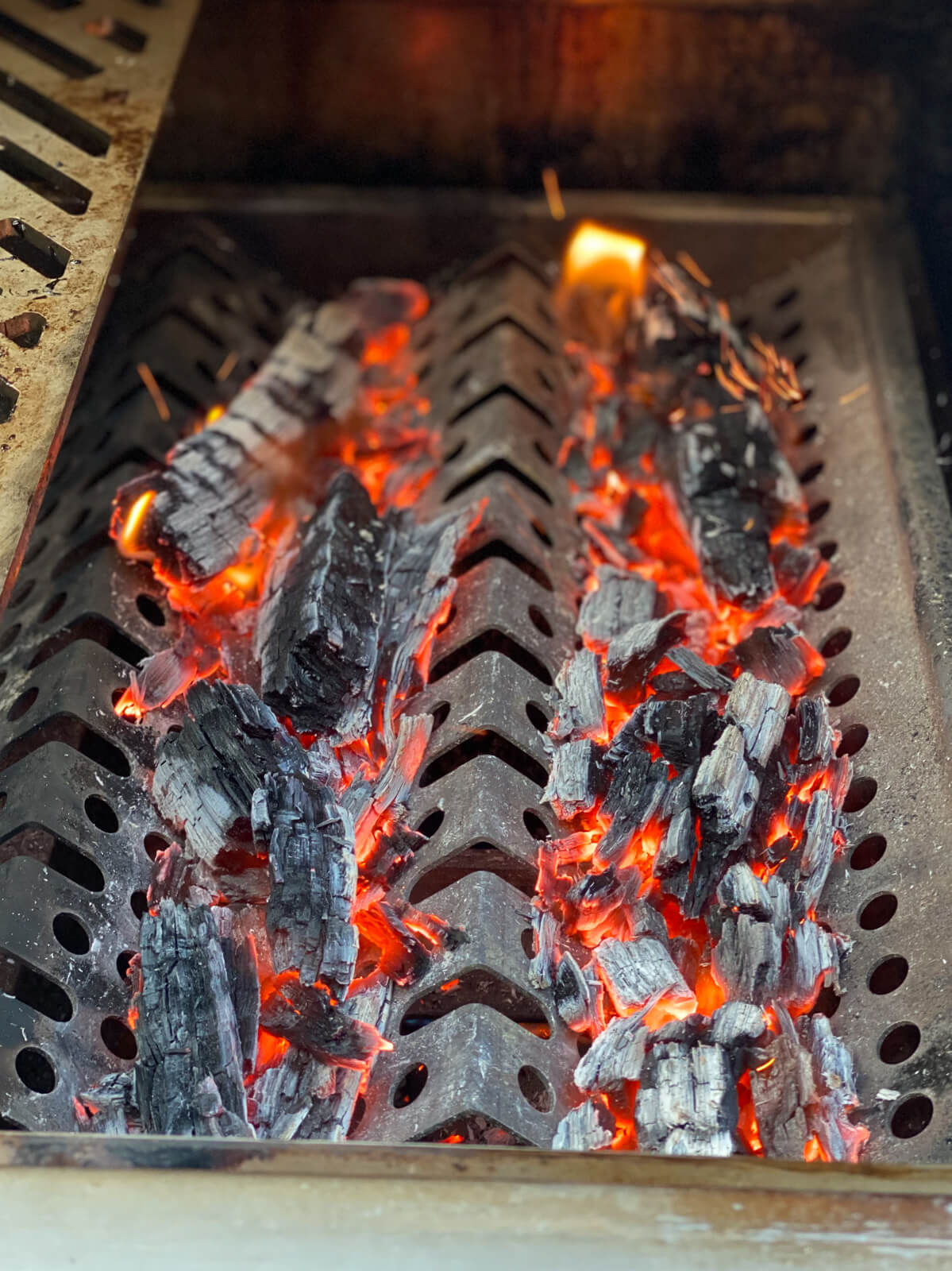 hot coals in a grill for making authentic Caribbean chicken