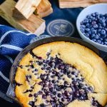 Smoked blueberry cobber in a cast iron pot
