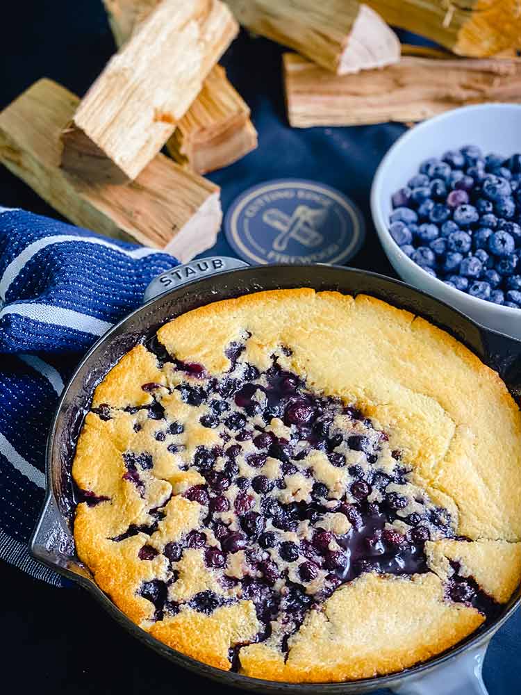 Smoked blueberry cobber in a cast iron pot