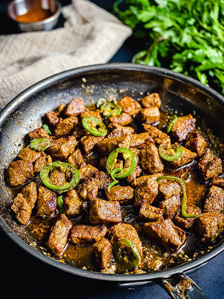 skillet of spicy cajun steak bites seared for the flavor of the Maillard reaction with Cajun spices