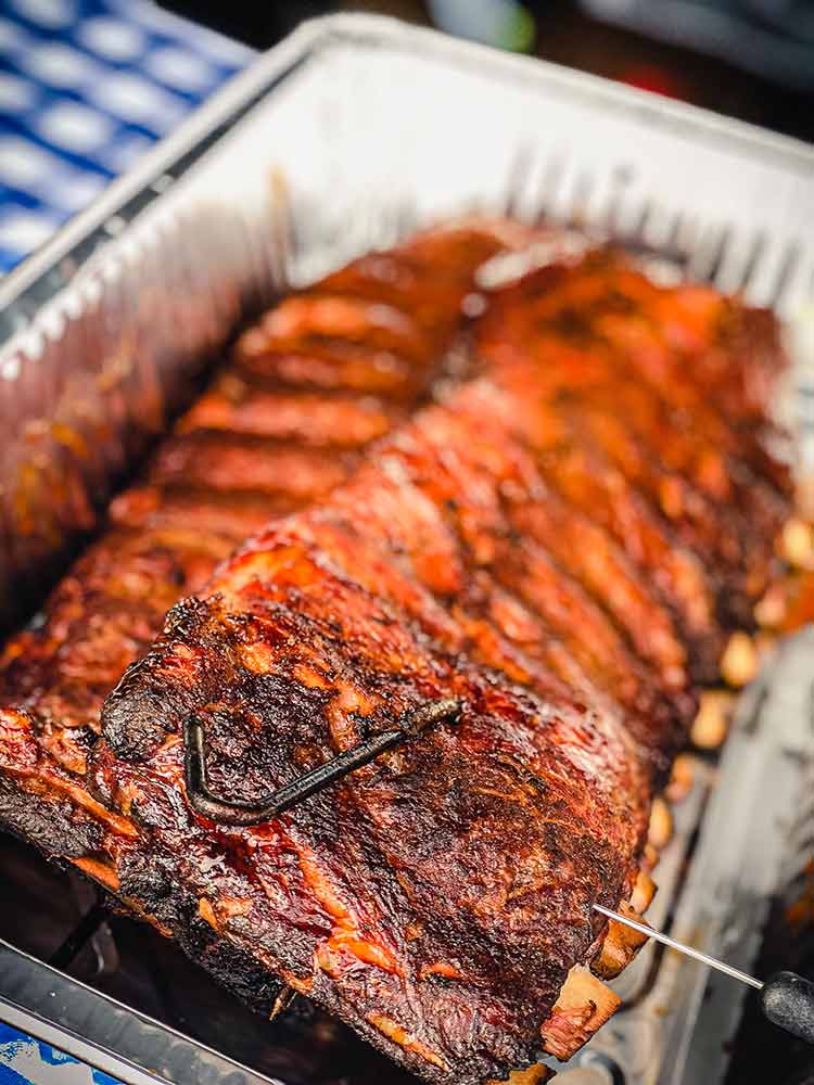 slide a temperature probe between the bones to test if ribs are done