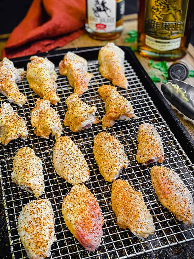 wings seasoned with barbecue rub and placed on a rack for cooking