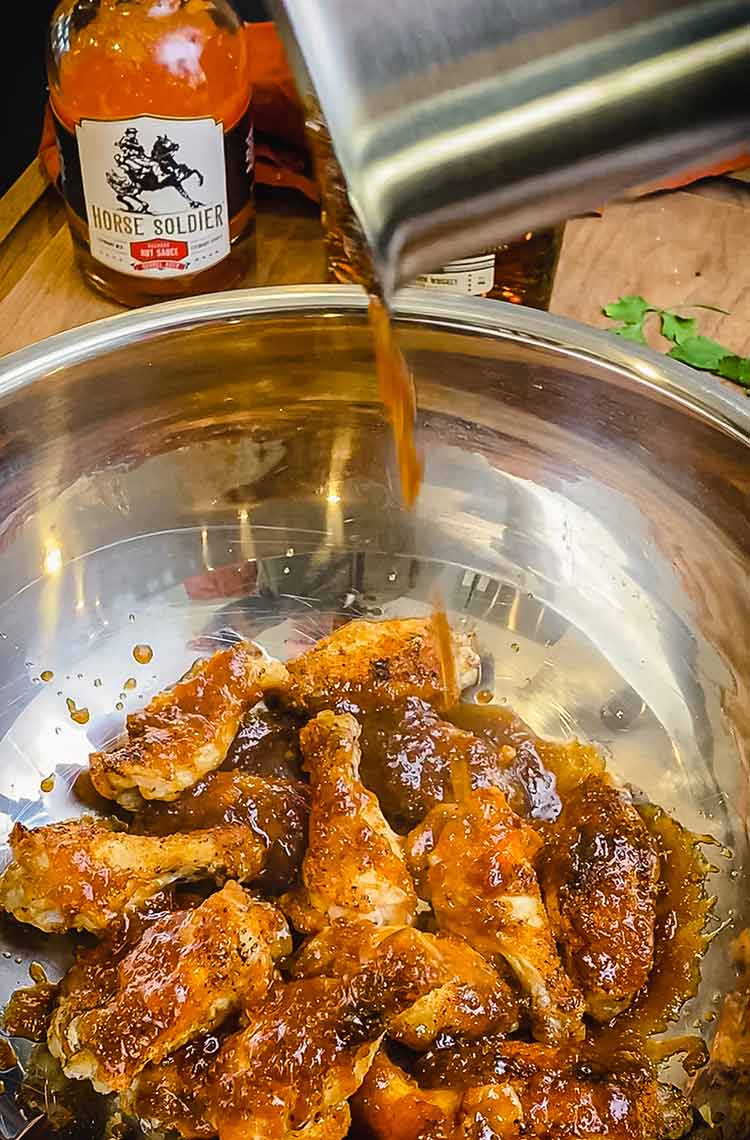 adding glaze to chicken wings