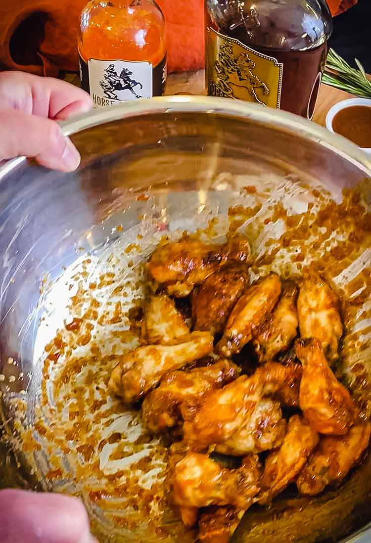 tossing wings in a big bowl to coat them