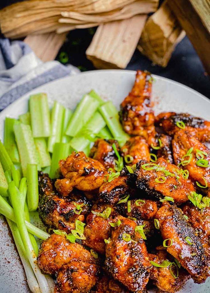 celery and buffalo wings with green onion garnish